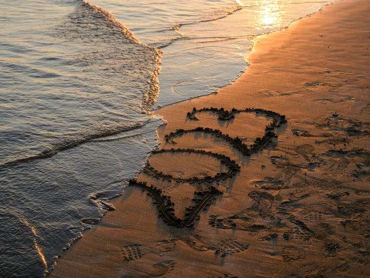 an ocean view with sand written in the sand