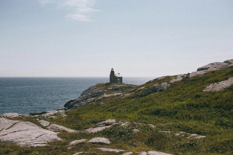 a man on top of a mountain near the ocean