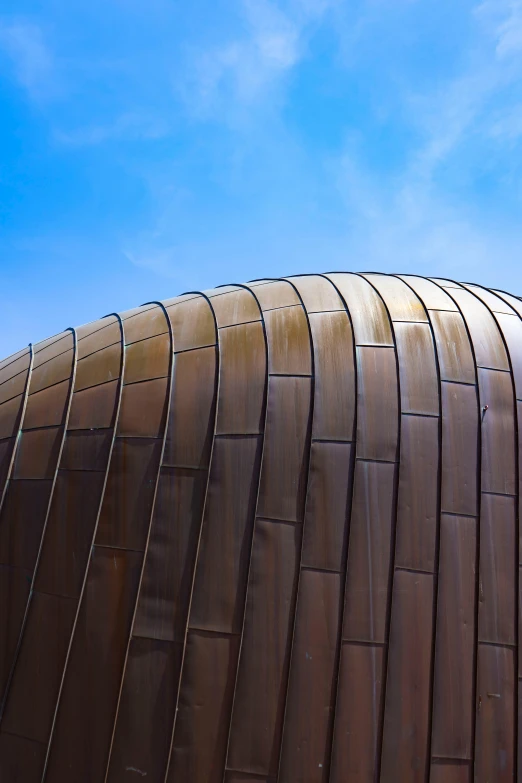 an image of a brown metal structure under a blue sky