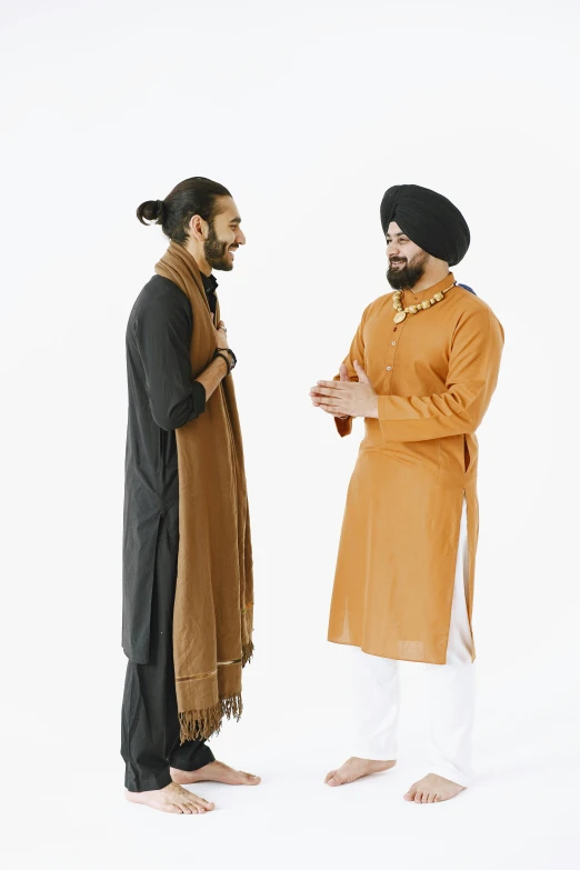 two men wearing desert clothing standing next to each other
