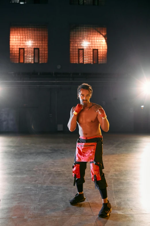 a man in a boxing outfit standing on a court