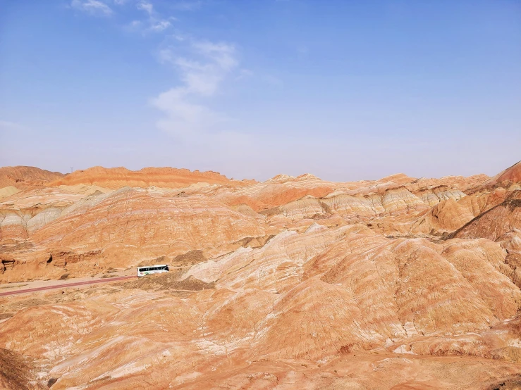 there is a van parked in the middle of the desert