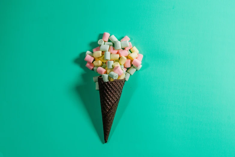 a chocolate cone with pastel candy candies in it