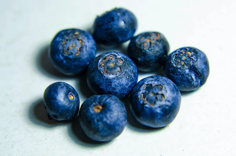 blueberries on a white surface that are almost gone