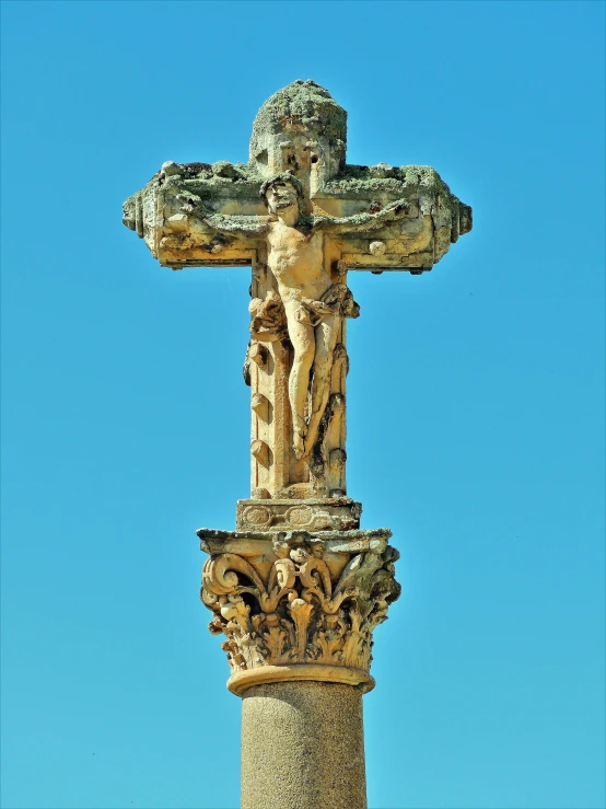 cross with the sky behind it and a blue sky