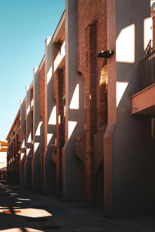 row of apartment buildings against a bright blue sky