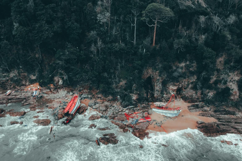 a boat on a beach that has fallen in the water