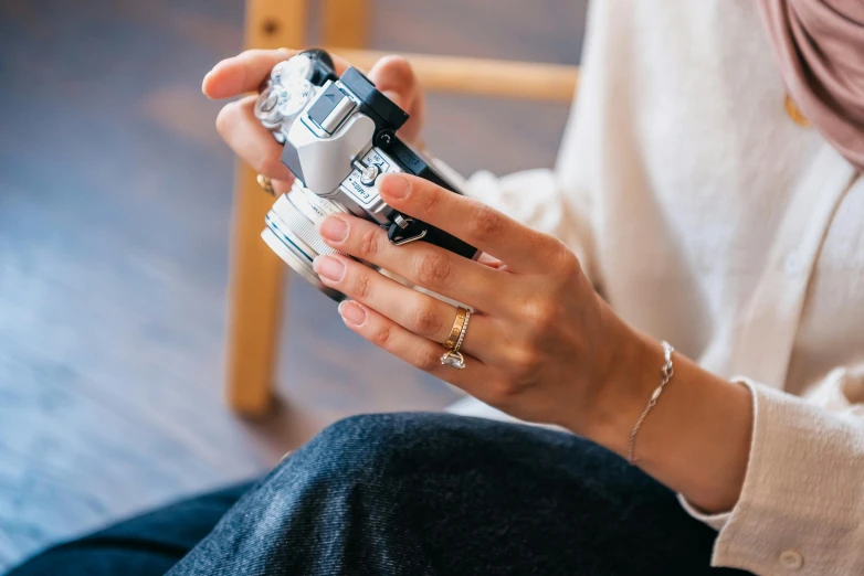 a woman is holding her cell phone in one hand