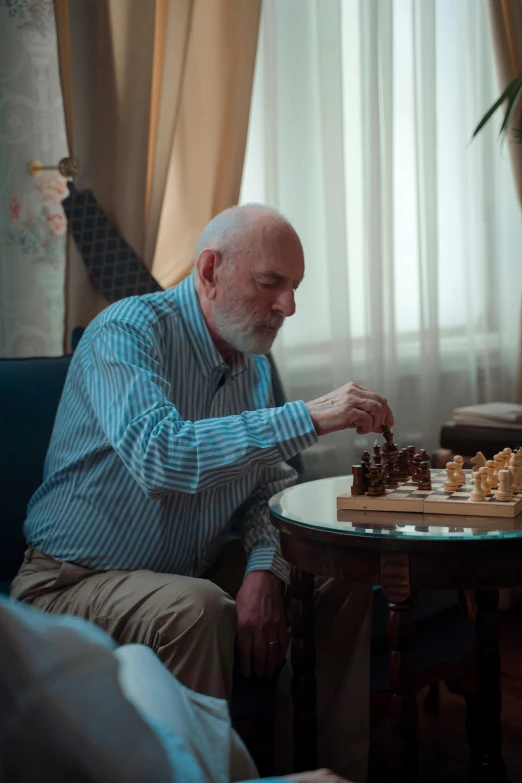 a man plays chess in a dimly lit living room