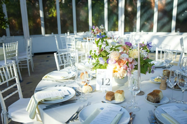 table setting with white linen and floral centerpieces