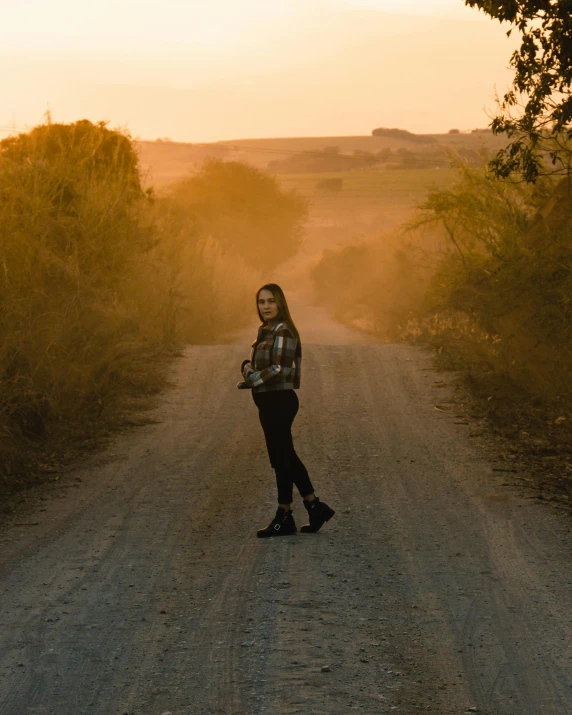 girl walking down dirt road in the countryside
