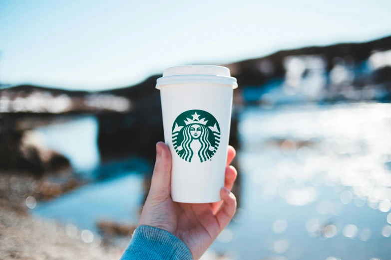 starbucks cup with logo on the front being held by person
