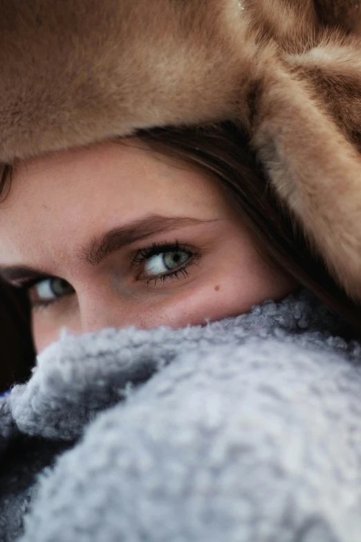 a woman with brown fur on top of her head