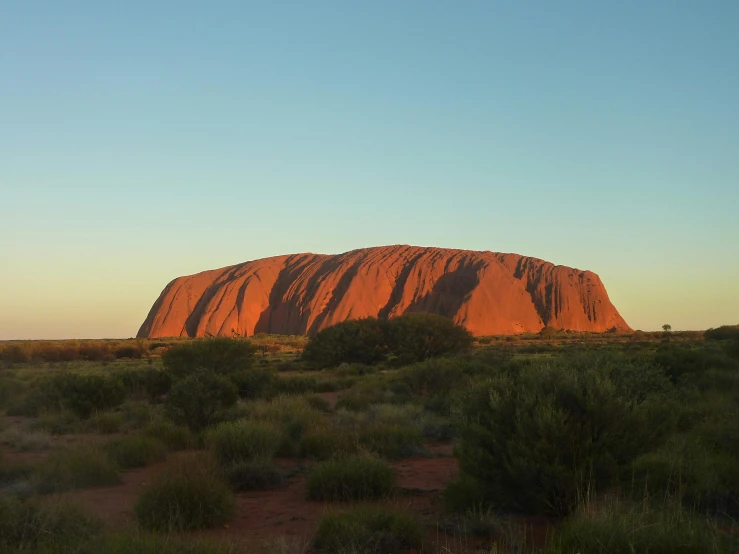 an outcropied rock that is in the background