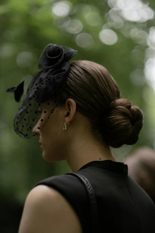 a woman with her hair up styled in a low bun