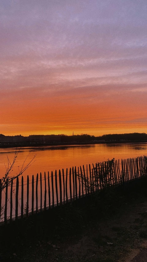 the setting sun sets over a body of water