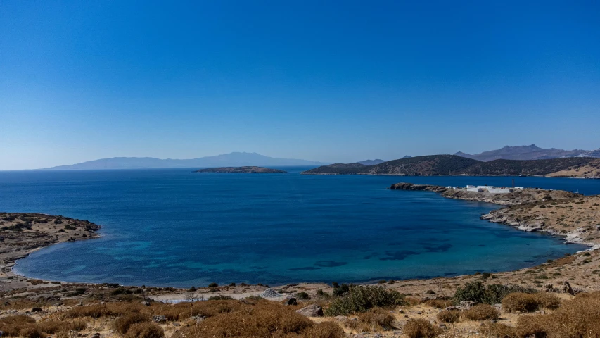 a large body of water sitting next to two mountains