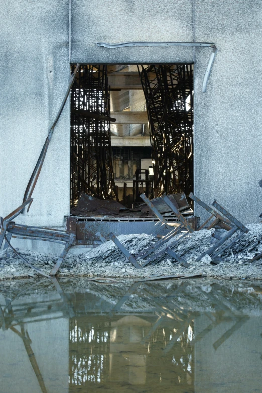 a reflection of windows and fencing at the entrance of a building