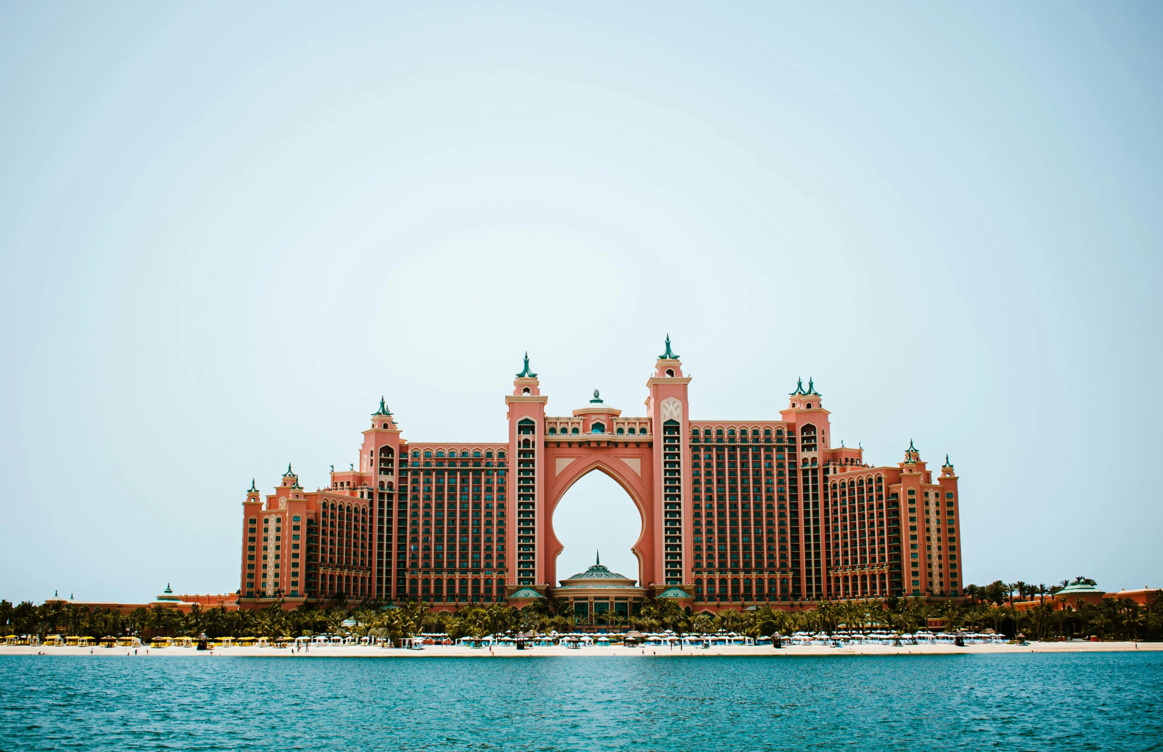 a tall brick building sitting over water with a lot of windows