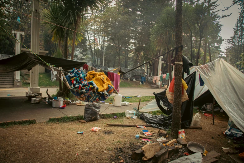 a tent in the foreground with a yellow ribbon hanging from it