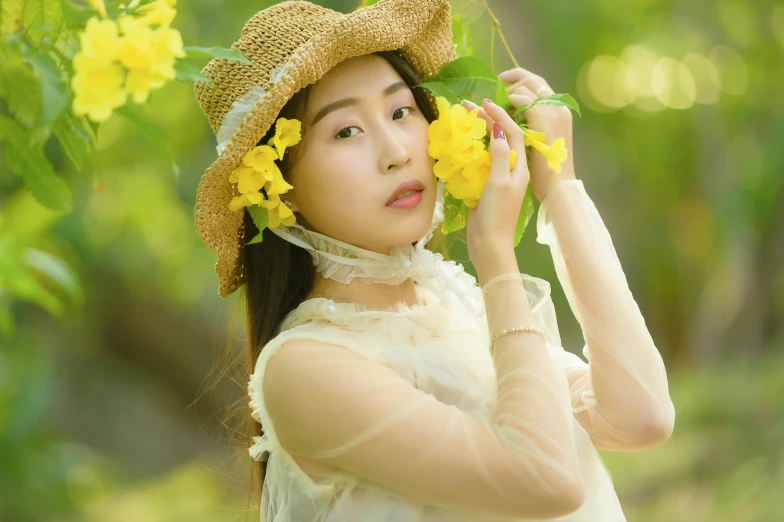 young woman posing wearing flowers wearing a hat