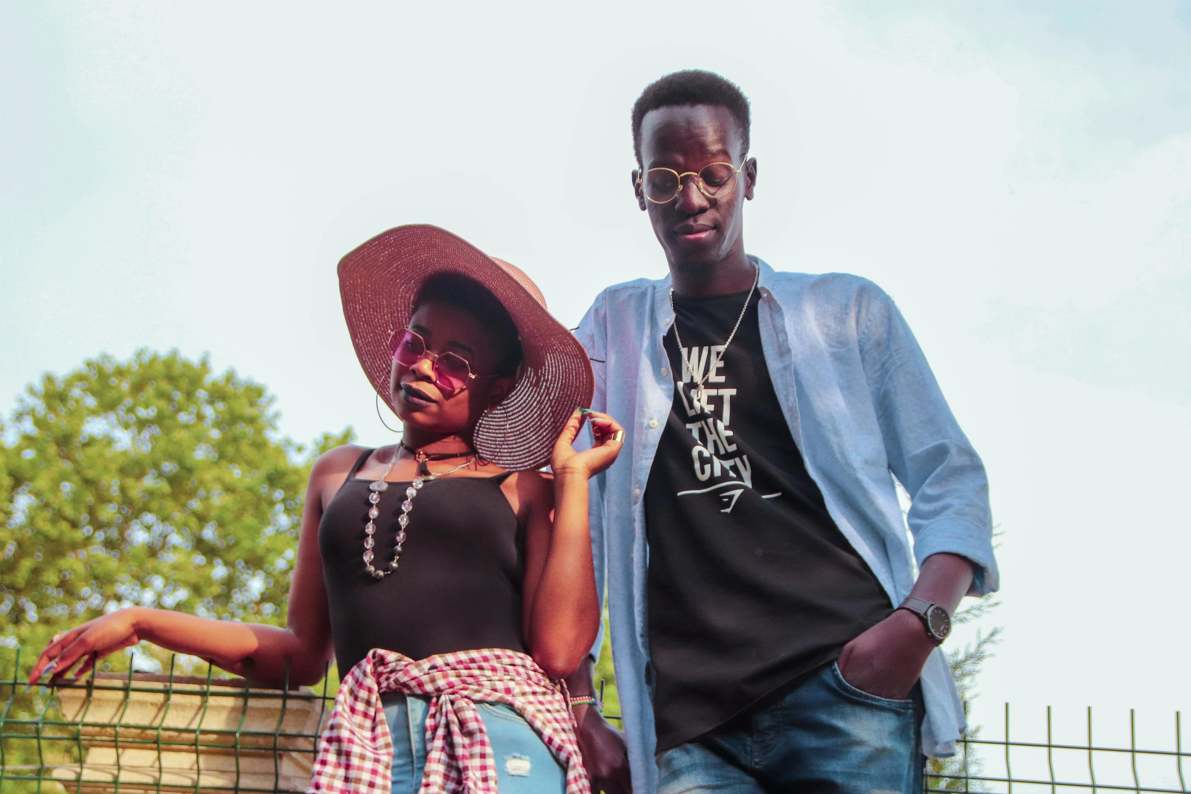 a man standing next to a woman on top of a field