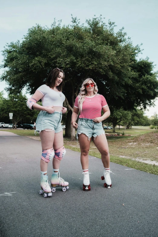 two girls in rollerblades wearing safety glasses and skates