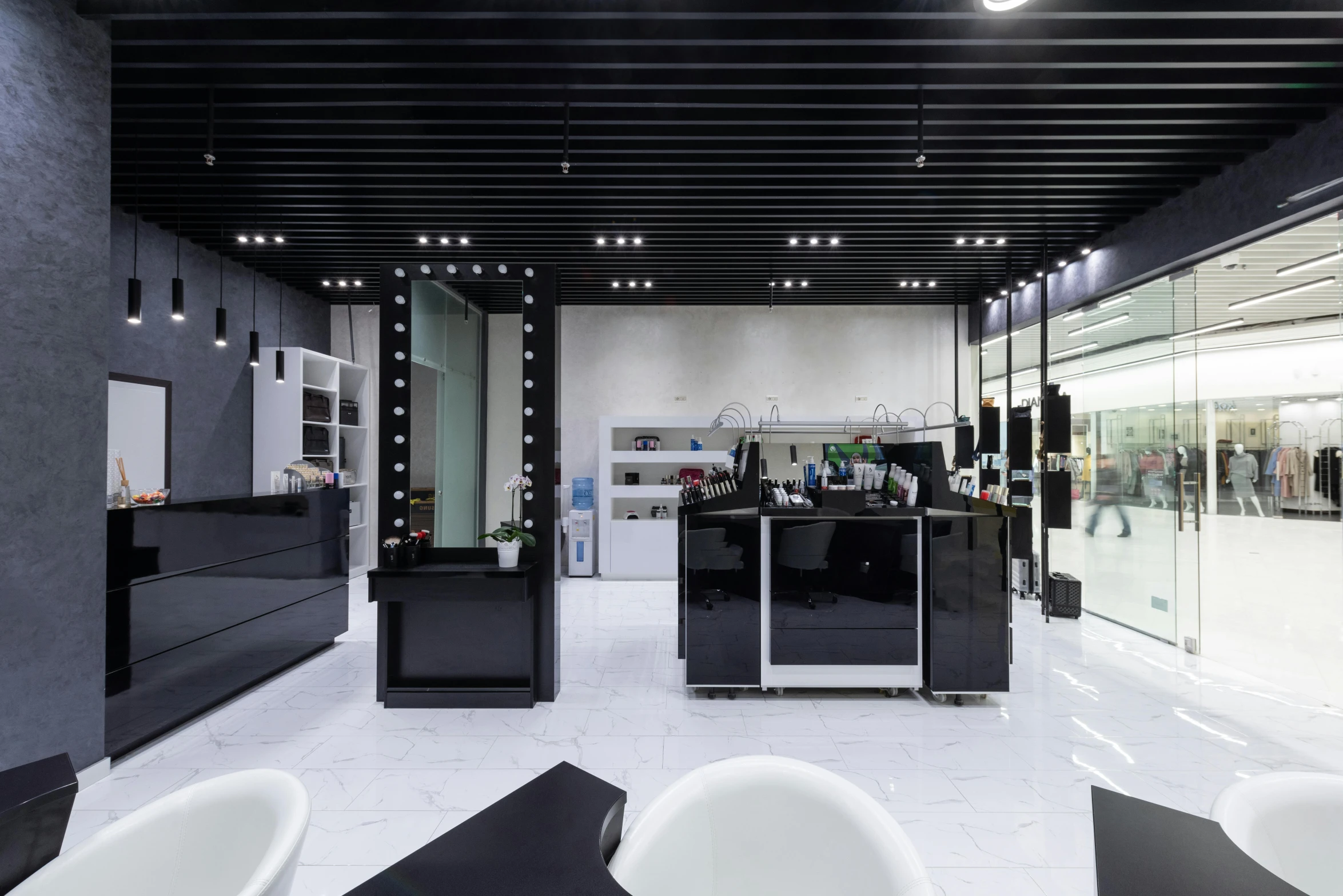 the interior of a salon with many chairs and sinks