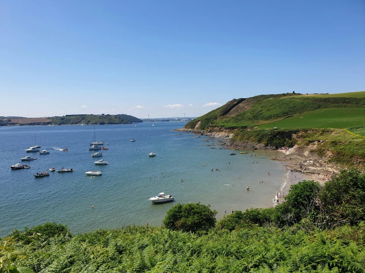 boats sit on the water near the shore