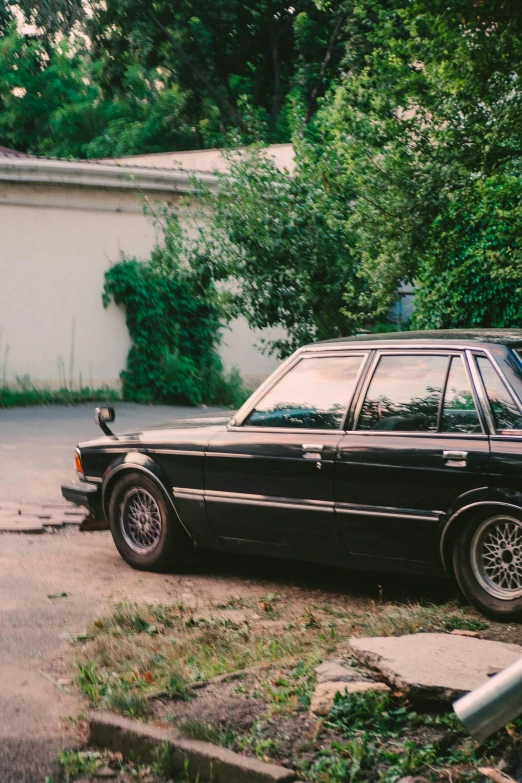 a car parked in a driveway near a house