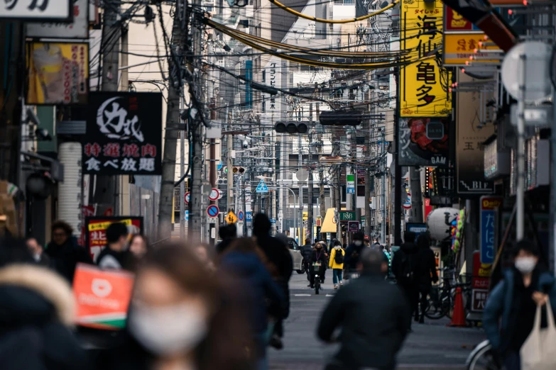 a city street filled with people walking and driving