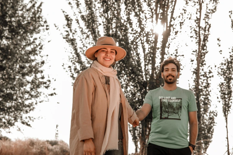 two men in hats hold hands together as they walk away