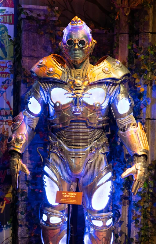 a large silver robot suit and helmet with glowing hands