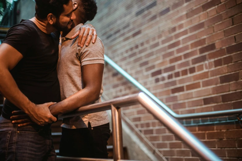 two men emcing each other as they hug