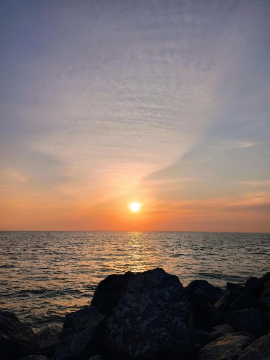 a bench sits near the edge of an ocean