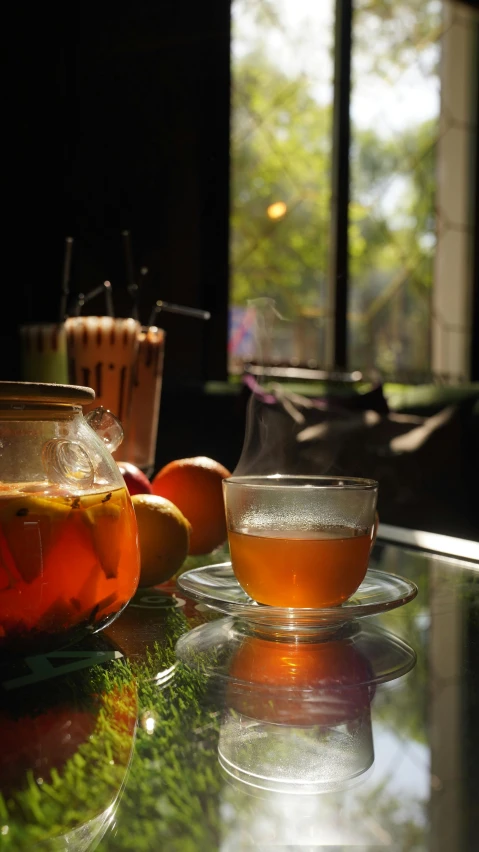 the tea is on a glass plate in front of a coffee maker