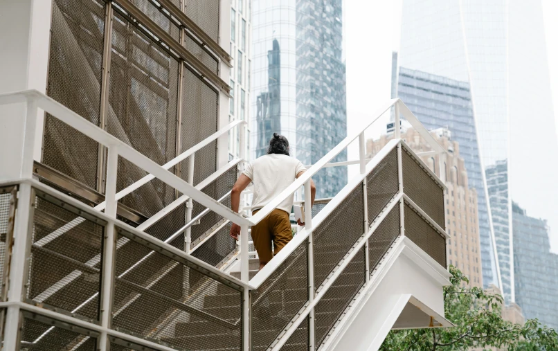 a man on a stair rail going up