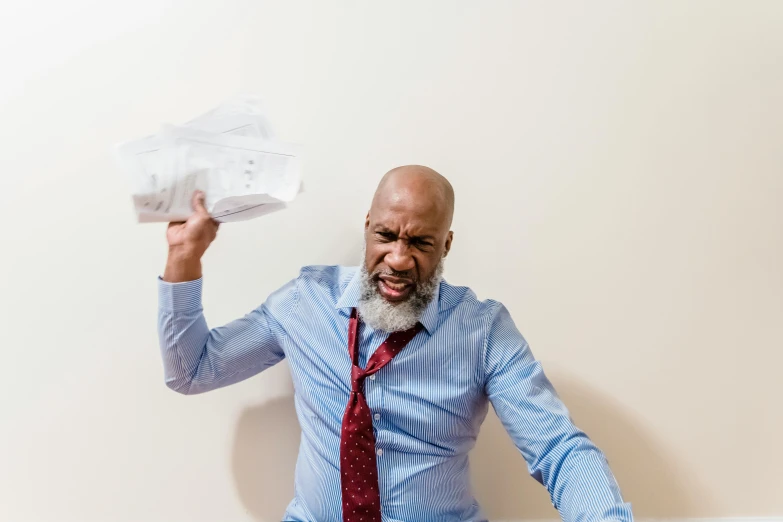 a man is holding up a plastic object