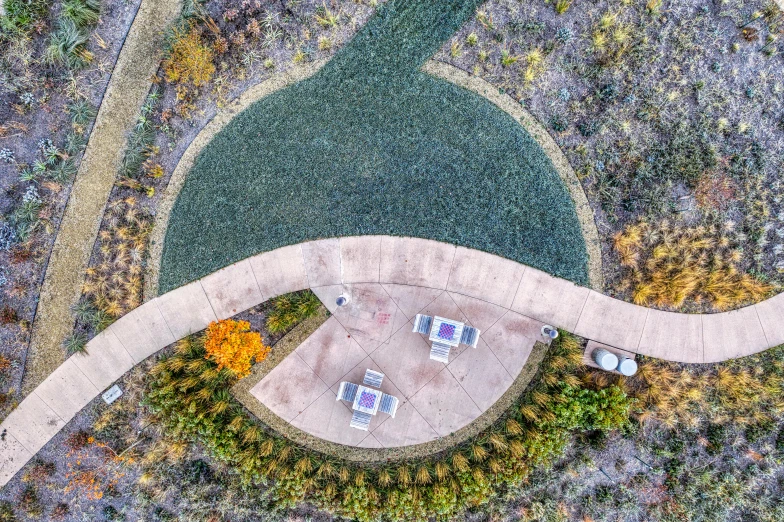 aerial pograph of a small park and curved walkway
