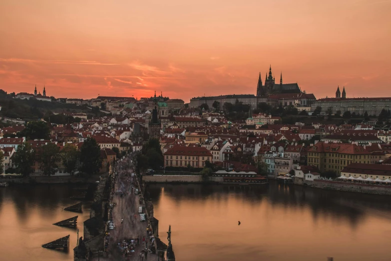 a sunset view of the river and some old buildings