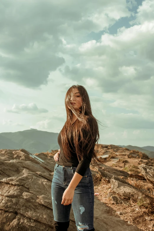 a woman on the beach posing with long hair