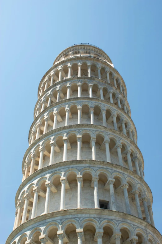 a very tall, white tower with several circular spaces on it