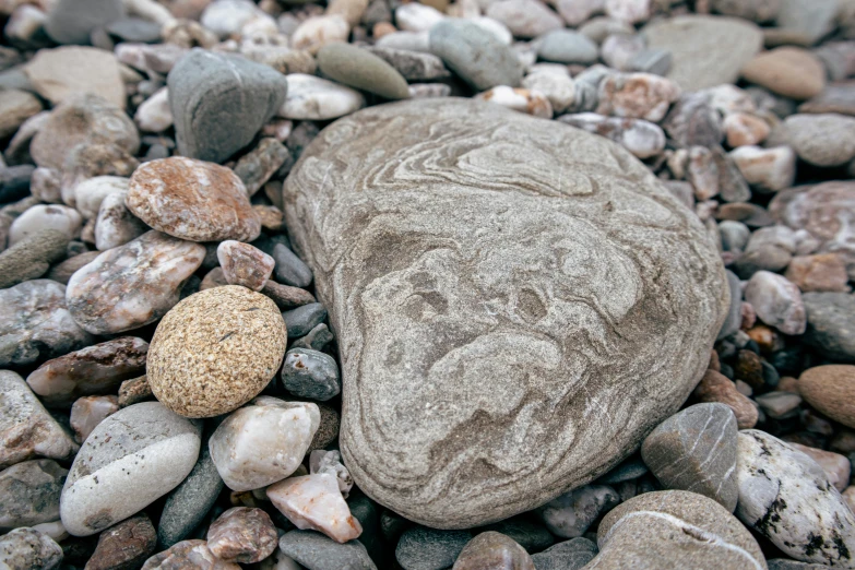 two rocks are covered by pebbles and dirt