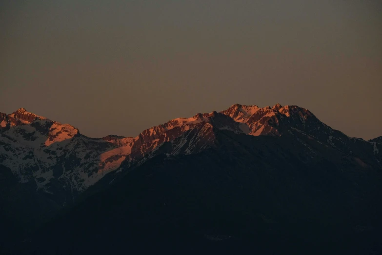 a mountain with a snowy peak at night