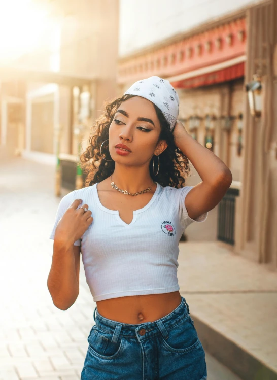 an african american woman with a white headband stands outside