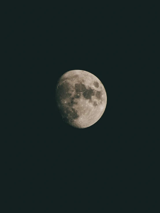 a half moon is shown lit up in the dark