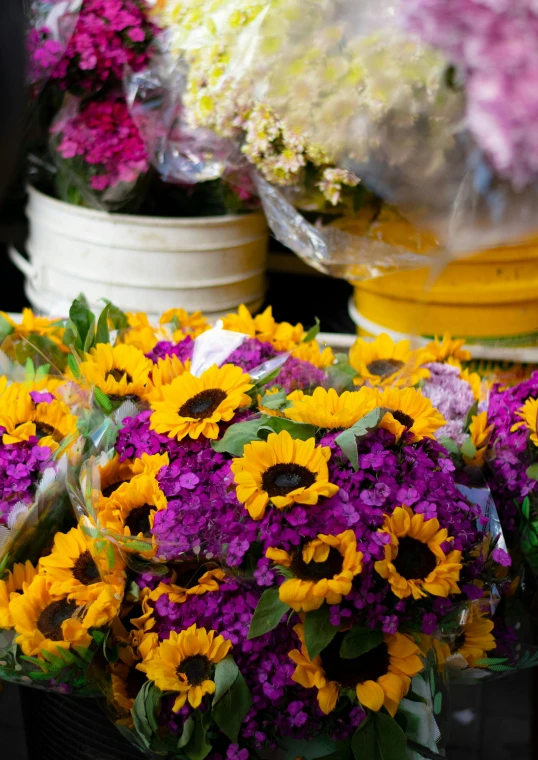 a bouquet of sunflowers, daisies and purple flowers for sale