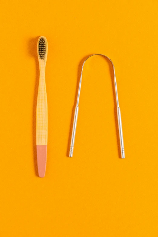 a toothbrush is next to an attachment on a yellow surface