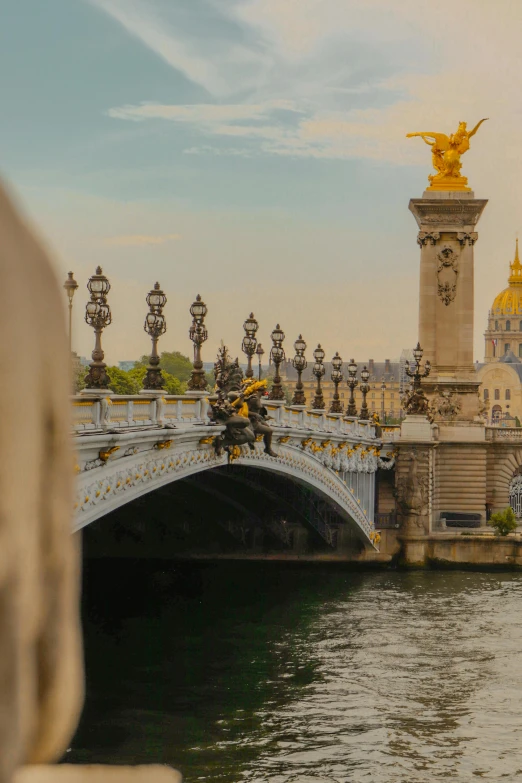 an image of a bridge and water with a building behind it