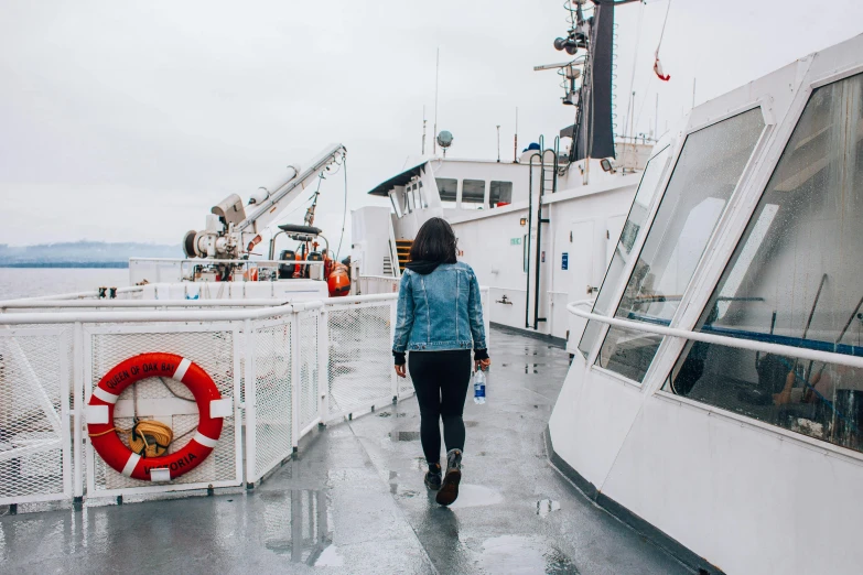 a woman walking along a boat during the day